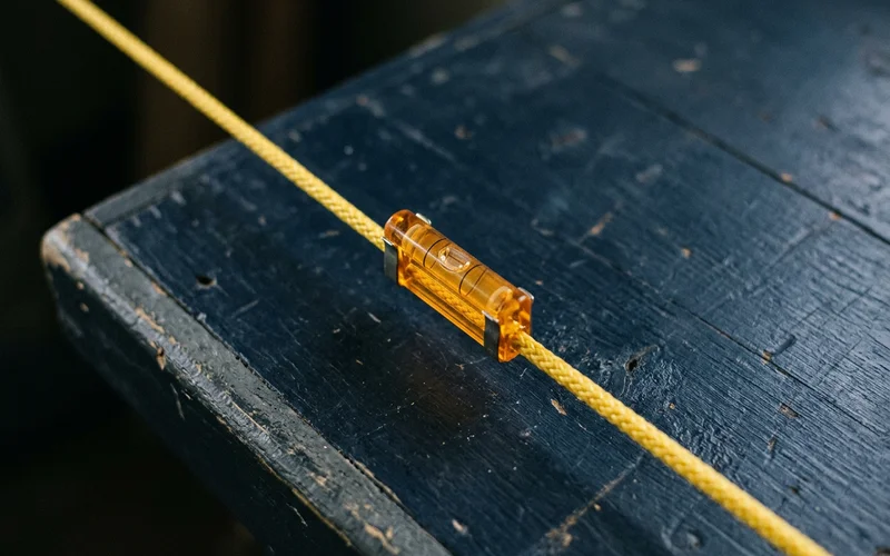 Minimal section diagram of a graded slope with an amber arrow showing the fall